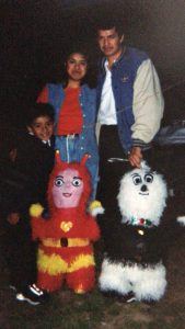Young Oscar with parents and piñatas